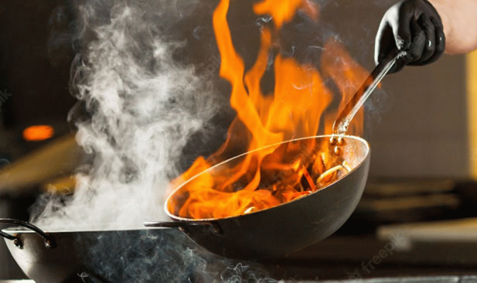 Cook Making Dinner in the Kitchen of High-end Restaurant